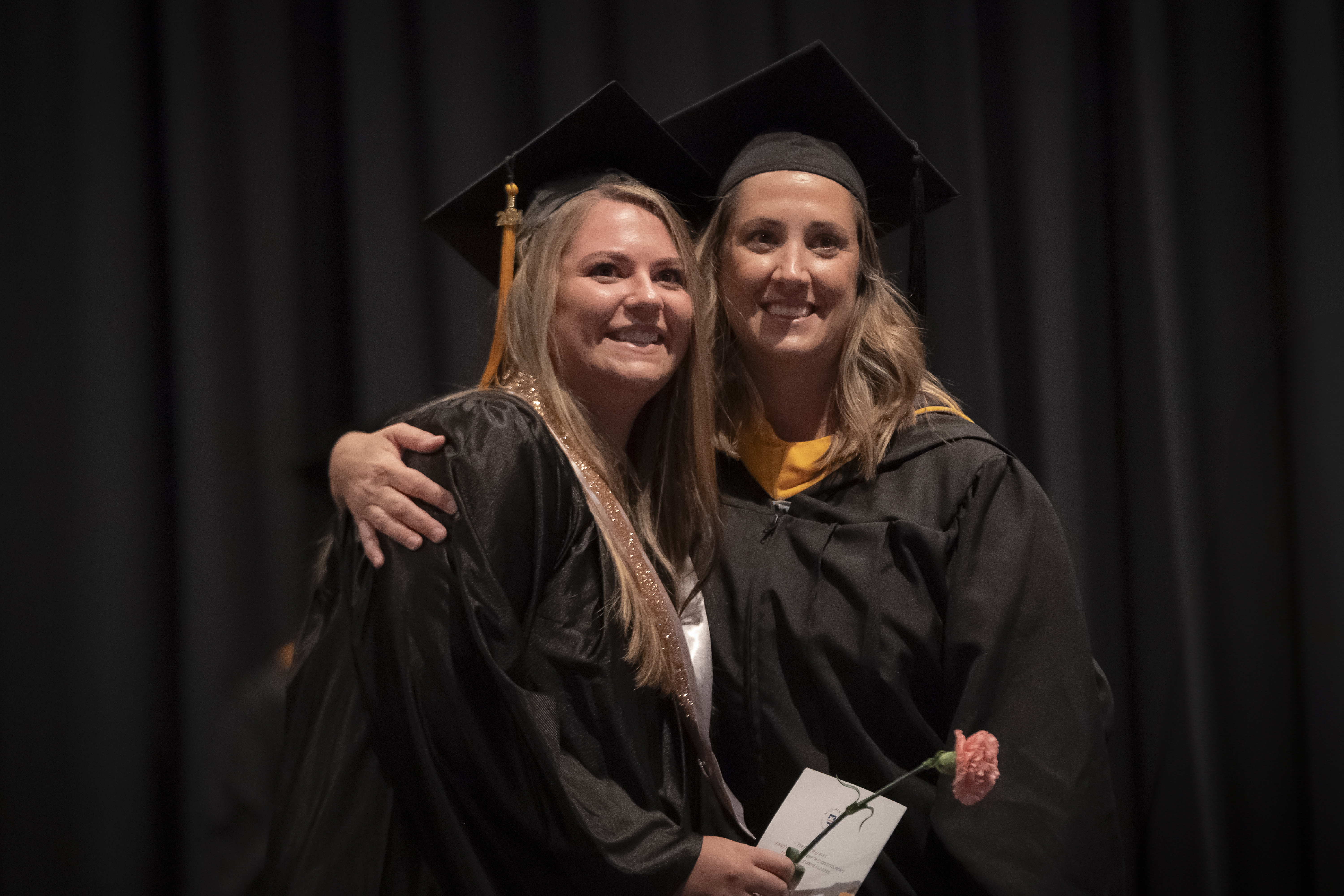 Ashley Knotts and Brett Niemeth, MPCC nursing instructor, pause for a photo during the Licensed Practical Nursing ceremony on Friday.