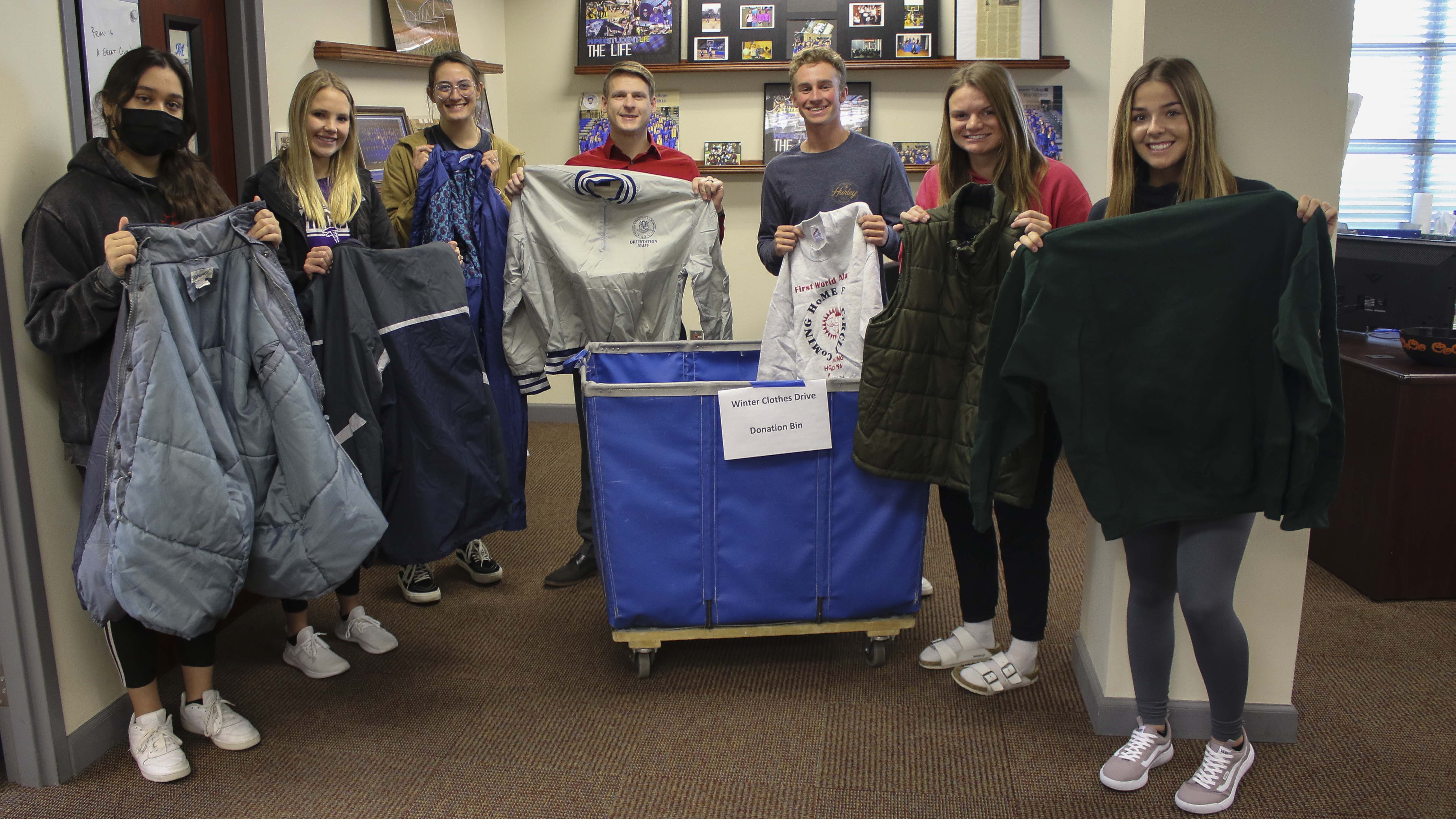 Members of the McCook Community College Student Senate gather around the bin where they are collecting warm-weather clothing for fellow students. Students include (from left): Leslie Hernandez, McCook; Neleigh Hauxwell, Culbertson; Annika Johnson, McCook; Reese Dellevot, McCook; Jordan DeMarce, Las Vegas; Taylor Thein, West Branch, Iowa; and Rae VanMilligan, Marion, Iowa.
